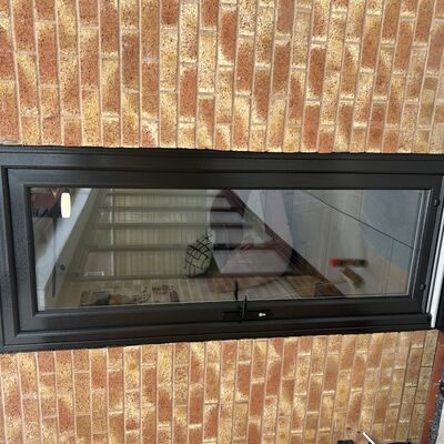 Newly fitted black uPVC back door with full glass panel and black handle.